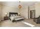 Serene main bedroom with neutral tones, decorative lighting, and a comfortable king-sized bed at 6452 Therfield Dr, Raleigh, NC 27614