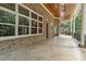 Expansive brick patio featuring wood ceilings, ceiling fans, and a seamless transition to the outdoor landscape at 6452 Therfield Dr, Raleigh, NC 27614