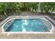 Refreshing pool with a stone patio, framed by wrought iron fencing and lush greenery, perfect for relaxation at 6452 Therfield Dr, Raleigh, NC 27614