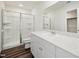 Bathroom features a glass-enclosed shower, a single vanity and a large mirror at 736 Kenyon Spring Dr, Zebulon, NC 27597