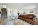 Open concept living room with view into the kitchen at 736 Kenyon Spring Dr, Zebulon, NC 27597