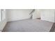 Spacious living room with carpeted floor, stairs, hard wood flooring and a large window at 736 Kenyon Spring Dr, Zebulon, NC 27597