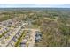 Aerial view of homes in a community with nearby lakes and natural wooded surroundings at 7652 Channery Way, Raleigh, NC 27616