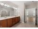 Bathroom featuring double sinks and walk-in shower with tile surround at 7652 Channery Way, Raleigh, NC 27616