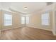 Bright bedroom featuring tray ceilings, wood floors, and plentiful windows at 7652 Channery Way, Raleigh, NC 27616