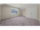 A cozy bedroom with light walls, plush carpeting, and a window that provides natural light at 7652 Channery Way, Raleigh, NC 27616