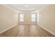 Spacious bedroom with wood floors and natural light streaming through windows at 7652 Channery Way, Raleigh, NC 27616