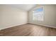 Bedroom featuring angled ceilings, natural light, and wood-look floors at 7652 Channery Way, Raleigh, NC 27616