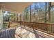 View of the spacious outdoor wooden deck perfect for entertaining with view of treeline and natural light at 7652 Channery Way, Raleigh, NC 27616