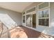 A spacious outdoor wooden deck with large windows and sliding glass doors at 7652 Channery Way, Raleigh, NC 27616