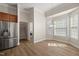 Dining nook with stainless fridge and adjacent laundry room at 7652 Channery Way, Raleigh, NC 27616