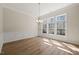 Elegant dining room with hardwood floors, chandelier, and large windows at 7652 Channery Way, Raleigh, NC 27616