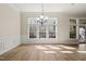 Bright dining room with hardwood floors, large windows, and modern chandelier at 7652 Channery Way, Raleigh, NC 27616