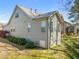 Rear view of house featuring neutral siding, a walkout basement, and architectural roof at 7652 Channery Way, Raleigh, NC 27616
