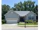 Charming single-story home featuring a gray exterior, well-manicured lawn, and attached two-car garage at 7652 Channery Way, Raleigh, NC 27616