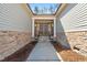 Welcoming front entrance with stone accents, double doors, and a pathway to the home at 7652 Channery Way, Raleigh, NC 27616