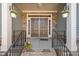 Inviting front porch with stone accents, double doors, and hanging floral arrangements at 7652 Channery Way, Raleigh, NC 27616