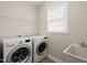 Laundry room featuring modern washer and dryer at 7652 Channery Way, Raleigh, NC 27616