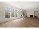 Spacious living room with hardwood floors, a fireplace, and large windows at 7652 Channery Way, Raleigh, NC 27616