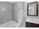 Bathroom with modern fixtures, tiled wall, and framed mirror provide functional style at 7706 Falcon Rest Cir, Raleigh, NC 27615