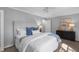 Cozy bedroom featuring soft lighting, a ceiling fan and neutral decor at 7706 Falcon Rest Cir, Raleigh, NC 27615