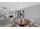 Cozy dining area featuring a wood table, comfortable seating, and views of the living room at 7706 Falcon Rest Cir, Raleigh, NC 27615