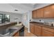 Kitchen features a sink, wood cabinets and countertops, and a view of the outdoor patio at 7706 Falcon Rest Cir, Raleigh, NC 27615