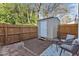 Backyard with a storage shed, privacy fence, and an outdoor seating area on a rug at 7727 Ohmann Ct, Raleigh, NC 27615