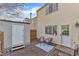 Inviting backyard patio area with a small shed, patio seating, and a door to the home at 7727 Ohmann Ct, Raleigh, NC 27615