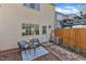 Cozy backyard patio with seating, a small table, and a view of the home's exterior at 7727 Ohmann Ct, Raleigh, NC 27615