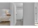 An ensuite bathroom is visible from the bedroom, featuring tile flooring and a shower at 7727 Ohmann Ct, Raleigh, NC 27615
