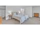 Bright bedroom featuring neutral walls, carpet, a large window, and comfortable furniture at 7727 Ohmann Ct, Raleigh, NC 27615