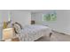 Bright bedroom featuring neutral walls, carpet, a large window, and comfortable furniture at 7727 Ohmann Ct, Raleigh, NC 27615