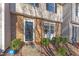 Inviting entryway with brick facade and black front door, surrounded by manicured landscaping at 7727 Ohmann Ct, Raleigh, NC 27615