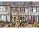 Charming townhome featuring tan siding, brick accents, and neatly landscaped front yard at 7727 Ohmann Ct, Raleigh, NC 27615