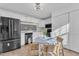 Well-lit kitchen with stainless steel appliances, white cabinets, and a cozy breakfast table at 7727 Ohmann Ct, Raleigh, NC 27615