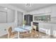 Modern kitchen with white cabinetry, stainless steel appliances, and a sunlit breakfast area at 7727 Ohmann Ct, Raleigh, NC 27615