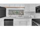 Stylish kitchen featuring a large sink, white countertops, and a pass-through to the living area at 7727 Ohmann Ct, Raleigh, NC 27615