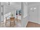 Bright kitchen nook with tile flooring, white cabinetry, and a cozy dining area near the door at 7727 Ohmann Ct, Raleigh, NC 27615