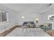 Well-lit living area with hardwood floors, modern furniture, and an open layout, perfect for relaxation at 7727 Ohmann Ct, Raleigh, NC 27615