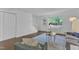 Open living area featuring a comfortable sofa, a white console, and convenient access to the front door at 7727 Ohmann Ct, Raleigh, NC 27615
