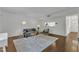 Inviting living room with a gray sofa, modern decor, and hardwood floors, perfect for relaxing or entertaining at 7727 Ohmann Ct, Raleigh, NC 27615