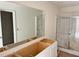 Spacious bathroom features a large mirror and a shower with sliding doors at 837 Kenyon Spring Dr, Zebulon, NC 27597