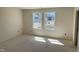 Sunlit bedroom with a view of the neighborhood through two large windows, awaiting personalized touches at 837 Kenyon Spring Dr, Zebulon, NC 27597