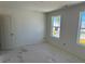 Unfinished bedroom with neutral color palette showcasing natural light from the windows at 837 Kenyon Spring Dr, Zebulon, NC 27597