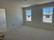 Bright, unfinished bedroom showcasing natural light through two large windows at 837 Kenyon Spring Dr, Zebulon, NC 27597