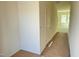 Bright hallway with white walls, doors, and a glimpse into a room with large windows at 837 Kenyon Spring Dr, Zebulon, NC 27597