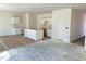 Kitchen with unfinished cabinets, island, and floors are being prepared for installation at 837 Kenyon Spring Dr, Zebulon, NC 27597