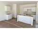 Kitchen with unfinished cabinets, island, and floors are being prepared for installation at 837 Kenyon Spring Dr, Zebulon, NC 27597