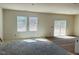 Unfinished living room with large windows and sliding glass door to the outside at 837 Kenyon Spring Dr, Zebulon, NC 27597
